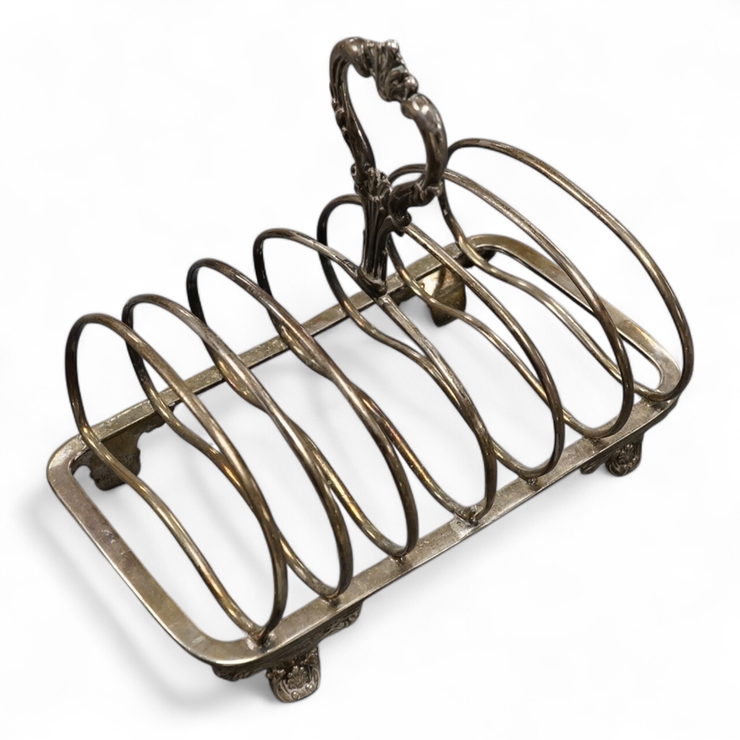 An early Victorian silver seven bar toast rack, with foliate ring handle, by William Robert Smily, London, 1843, length 16.6cm 7.3oz (damaged).